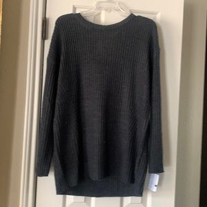 Dark grey light weight sweater with open upper back.